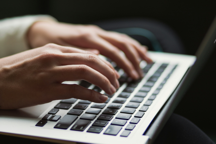 Person typing on a keyboard