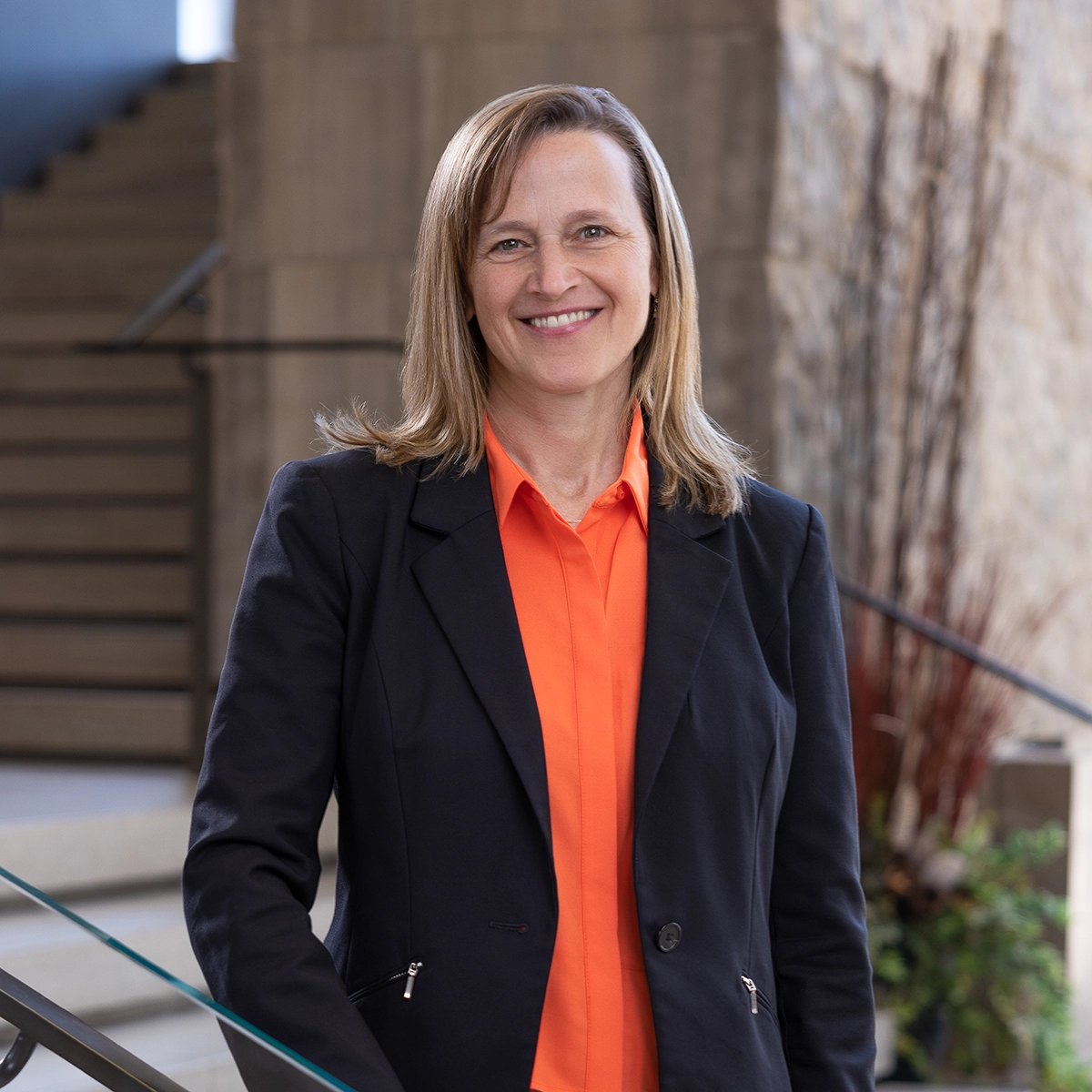 Vice-President (Research) Penn Pexman standing and smiling on a set of stairs