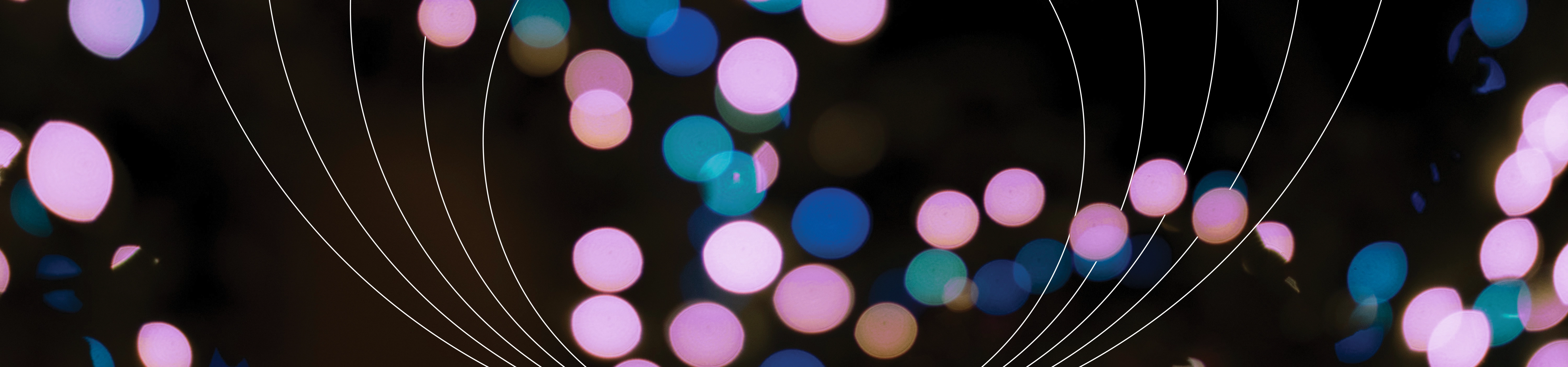 blue, pink and purple spotlights in front of concentric circles