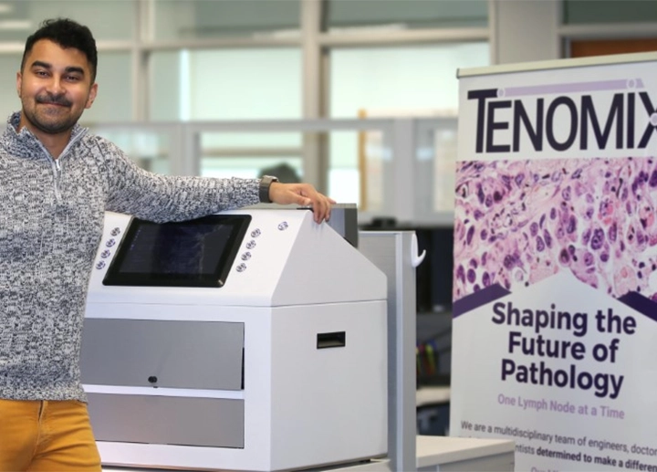 Tenomix Team Member Saumik Biswas with imaging tech and tenomix banner